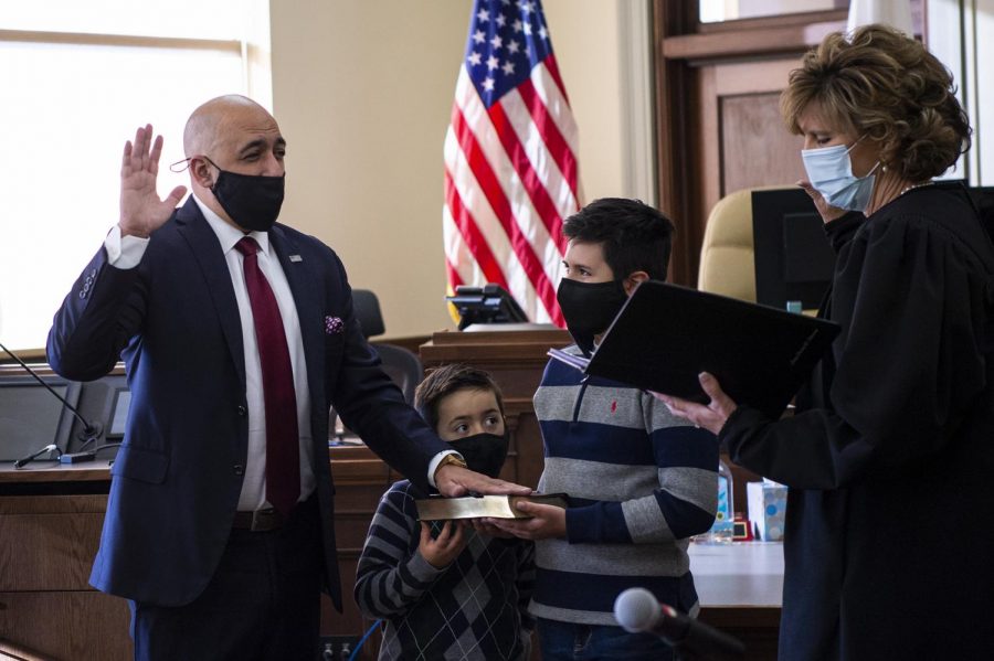 States Attorney Joe Cervantez, left, is sworn in by presiding judge Christy Solverson, while Cervantezs sons Cason, 7, and Canon, 10, hold the bible during the ceremony at Jackson County Courthouse in Murphysboro, Ill. Dec. 1, 2020.