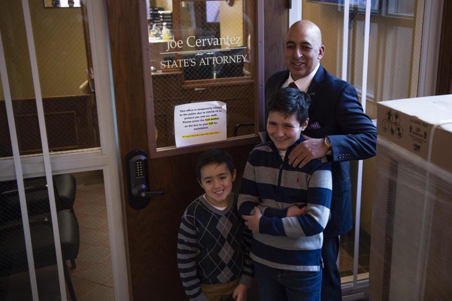 Newly sworn in States Attorney Joe Cervantez, center, poses for a photo outside his office with his sons Cason, 7, and Canon, 10, at the Jackson County Courthouse in Murphysboro, Ill. Dec. 1, 2020.