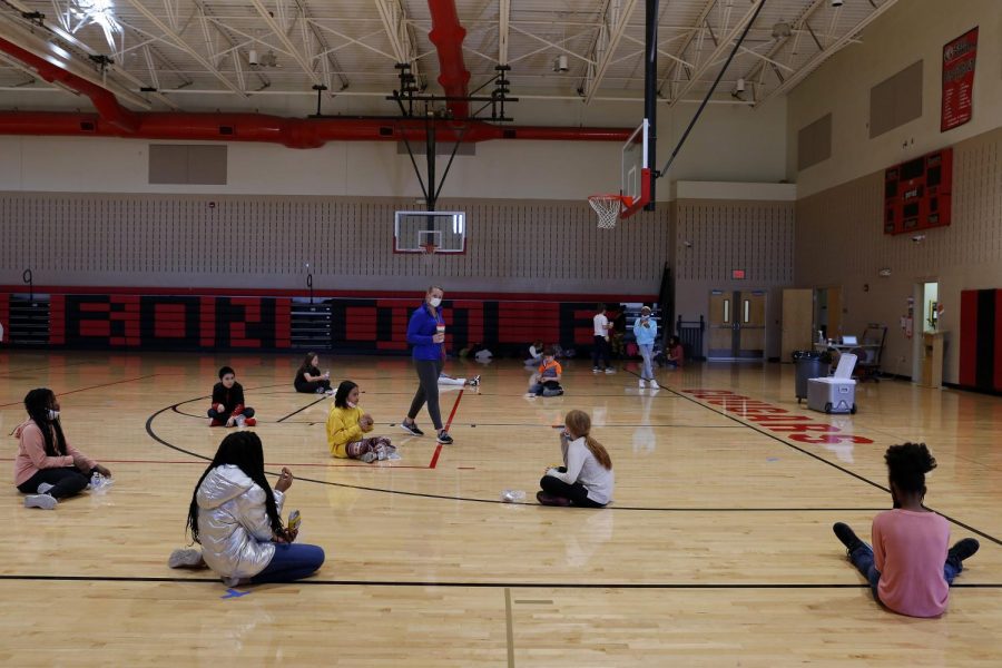 Carbondale Middle School physical education teacher, Coach Haley Karayiannas, center, chats with her socially distanced students on the last day of in-person learning, Friday, November 13, 2020.
