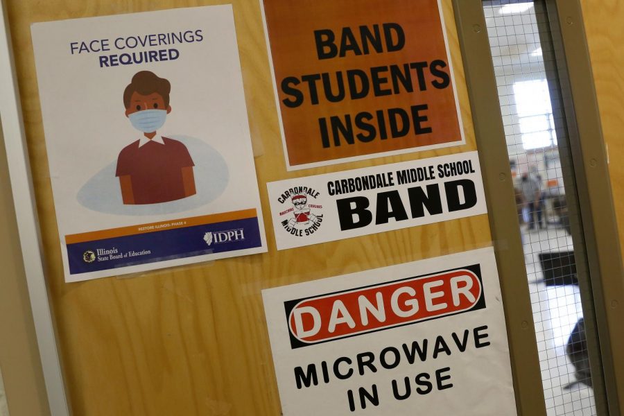 At Carbondale Middle School, an Illinois State Board of Education sign on a classroom door instructs anyone entering that face masks are required, Friday, November 13, 2020.

