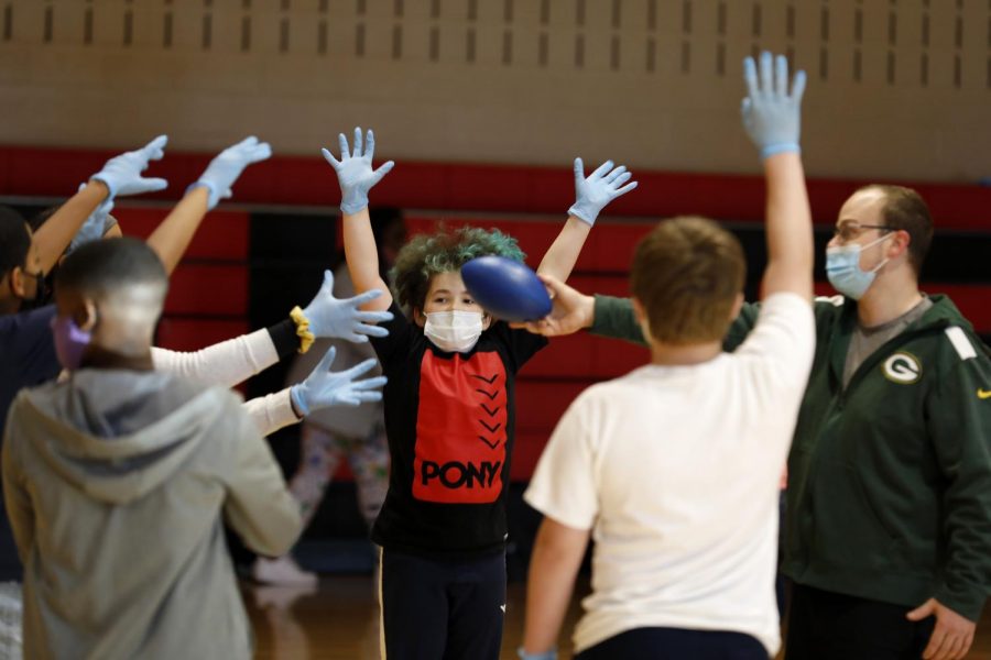 Second year Physical Education and Social Studies teacher, Tyler Mink gets Phoenix G. and his classmates started on a game of touch football at Carbondale Middle School, on the last day of in-person learning, Friday, November 13, 2020.

