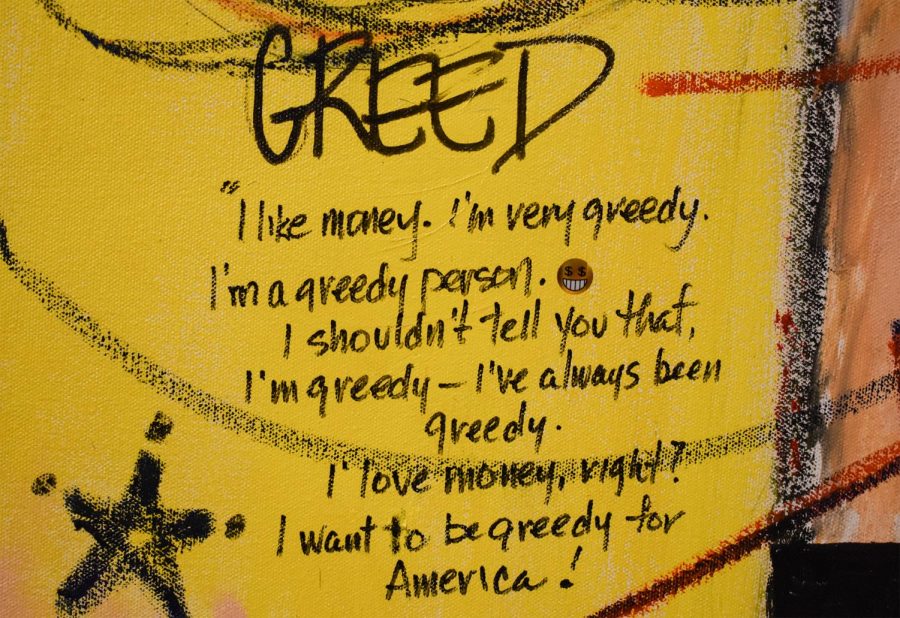 A close up of the piece “Introduction to the Sins” made by artist Tim Atseff, features a quote from former president, Donald Trump  “GREED, I like money, I’m very greedy. I’m a greedy person. I shouldn’t tell you that, I’m greedy- I’ve always been greedy. I love money, right? I want to be greedy for America!” The exhibit features 50 years of work. The paintings are based off of Atseffs interpretation of violence and persecution of Donald Trump.