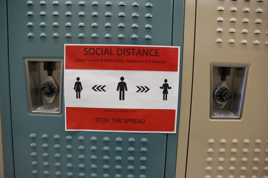 A sign on a locker reminds students to socially distance at Carbondale Middle School Nov. 13, 2020.

