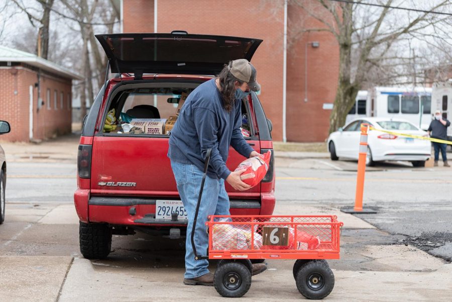 Donald Dunn loads food into his car on Sunday, Feb. 28, 2021, at Victory Dream Center in Carbondale, Ill.