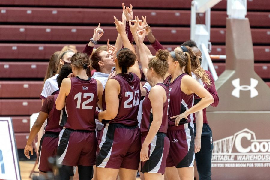 The SIU women's basketball team raises their hands in a pump up before the game against Illinois State on Saturday, Feb. 6, 2021, in the Banterra Center at SIU. The Salukis went on to win 43-41 to the Redbirds.