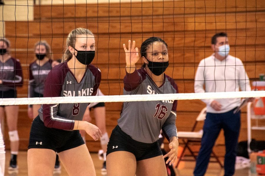 Hannah Becker (8) and Imani Hartfield (16) prepare to receive and block their opposing team, University of Iowa, on Feb. 22, 2021, Carbondale Ill.