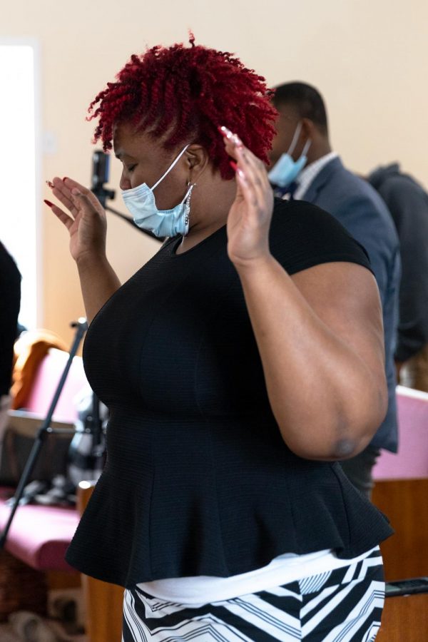 Melayne Ross holds her hands up during worship on Sunday, Feb. 8, 2021, in Murphysboro, Ill. According to Neophansya Robinson, the women who sing on the praise team sing every Sunday and have not missed  one Sunday during the pandemic.