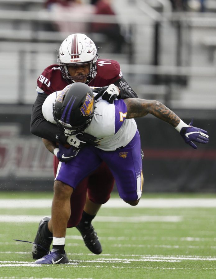 Saluki defensive end Anthony Knighton tackles Panthers running back Dom Williams during the SIU’s 17-16 win at Saluki stadium on Saturday, March 13, 2021.