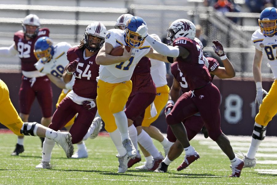 Saluki safety Qua Brown, 24, and linebacker Bryce Notree, 54, chase down the Jackrabbits quarterback during Saturday’s game at Saluki Stadium on March 20, 2021. SIU lost to South Dakota State by the score of 44-3.