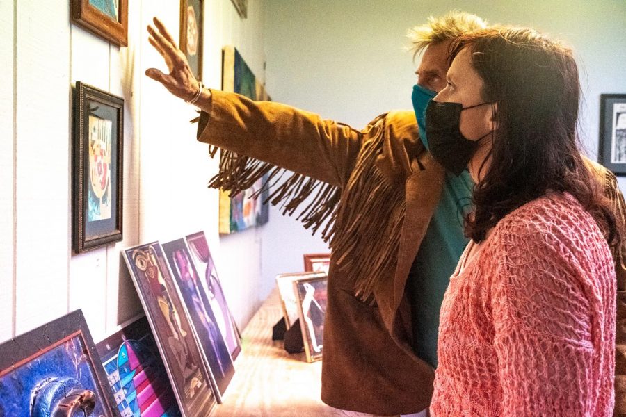 Elissa Kimball and Larry Avery talk about their artwork on Thursday, March 11, 2021 at the Center for Empowerment and Justice in Carbondale, Ill. “We do paintings so that anyone can buy them, and the funds come from [the art sold] to run this center,” Kimball said. “We also accept donations. Anything like books, clothes and [we give them to] the people who were victims of violence.”