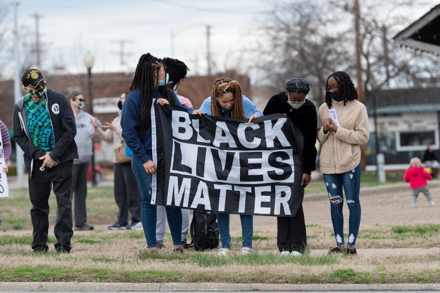 Protestors hold up a Black Lives Matter sign during the protest on the one-year anniversary of Breonna Taylor’s death on Saturday, Mar. 13, 2021 at the Carbondale Pavilion in Carbondale, Ill. 