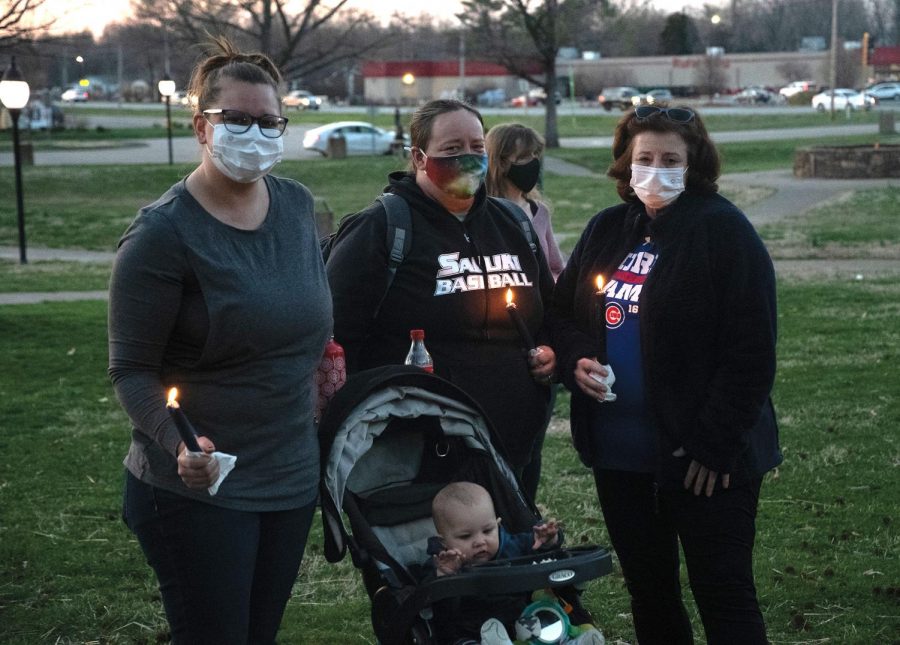 Diane Ashley, Erin Ashley and Jay Mize pose with candles at the Asian Lives Matter event organized by Sunrise Movement Southern Illinois on Sunday, March 21, 2021, at Lenus Turley Park in Carbondale, Ill. 