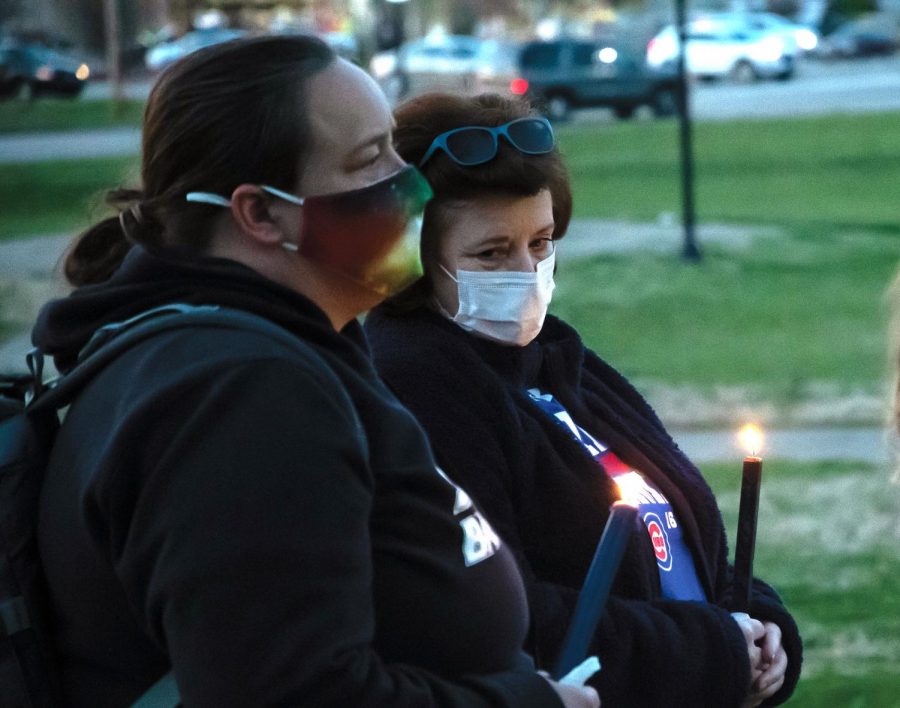Erin Ashley and Jay Mize, local residents of Carbondale, stand up holding candles to show support in the Asian Lives Matter event organized by Sunrise Movement Southern Illinois on Sunday, March 21, 2021, at Lenus Turley Park in Carbondale, Ill. “We have to speak out about racism as a community,” Mize said.