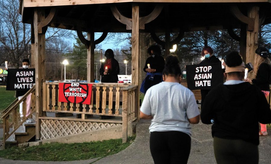 Members from the organizing team stand up with different messages in the Asian Lives Matter event organized by Sunrise Movement Southern Illinois on Sunday, March 21, 2021, at Lenus Turley Park in Carbondale, Ill. The goal of the event was to show a peaceful protest against racial violence, especially Asians. 