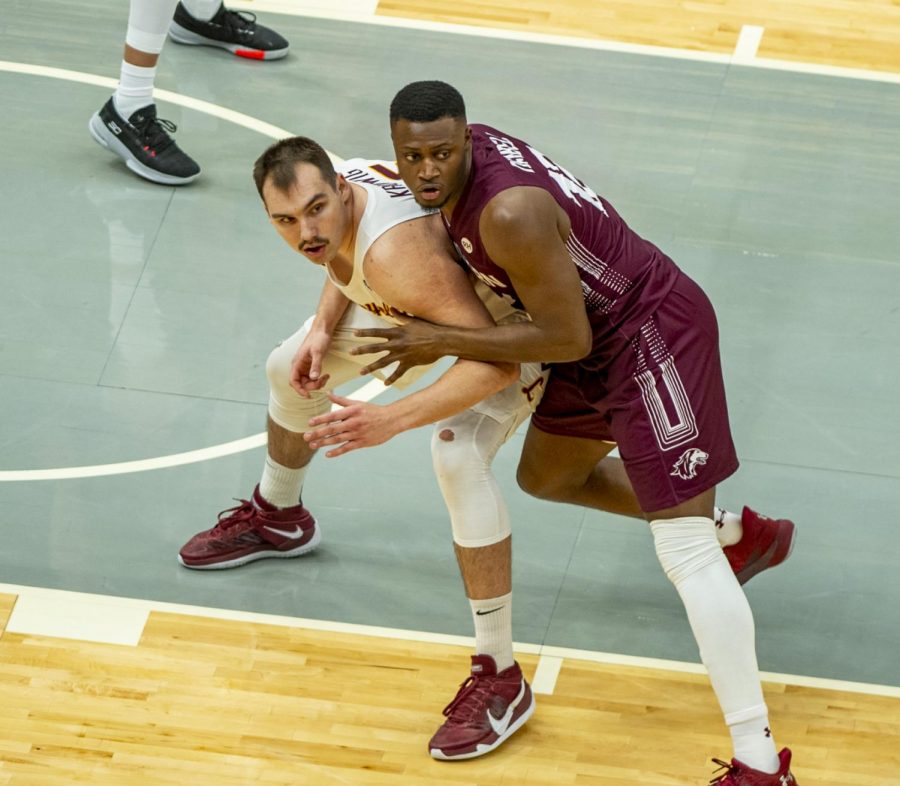 SIU forward Sekou Dembele heavily guards Cameron Krutwig of Loyola during the Salukis 49-73 loss against Loyola in the Arch Madness tournament on Friday, March 5, 2021 at the Enterprise Center in St. Louis, MO.   