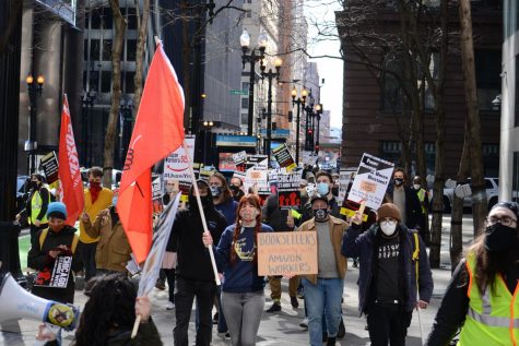 Supporters of a unionization effort at an Amazon warehouse in Alabama march on the sidewalk for a Day of Solidarity on March 20, 2021, in downtown Chicago, Ill. 