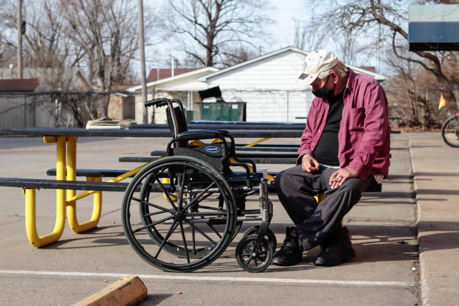 A Homeless military veteran, who did not wish to give his name, sits outside of the Carbondale Warming Center Feb. 25, 2021, in Carbondale, Ill. “Most people here have got some kind of story,” he said. Sophie Whitten | @swhittenphotography