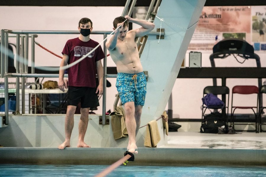 Joshua Virella, an undergraduate student in the Physics Department, tries to balance on the rope at the April Pools Day event Thursday, April 1, 2021, at SIU Recreation Center in Carbondale, Ill. “I am here with my friend and we are enjoying it a lot after a long time,” Virella said. 