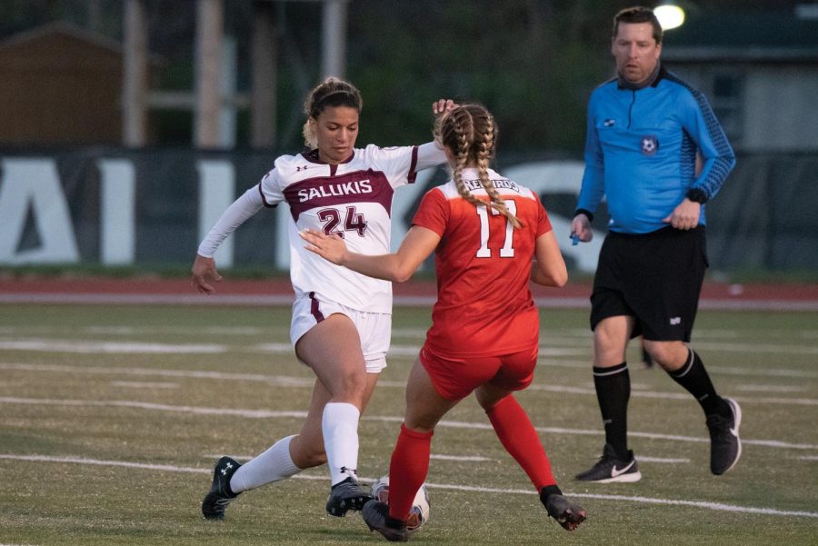 Maya Warrior (24) dribbles the ball to get past the opponent midfielder in the game against Illinois State University on Saturday, April 3, 2021 at Lew Hartzog Track and Field Complex in Carbondale, Ill.