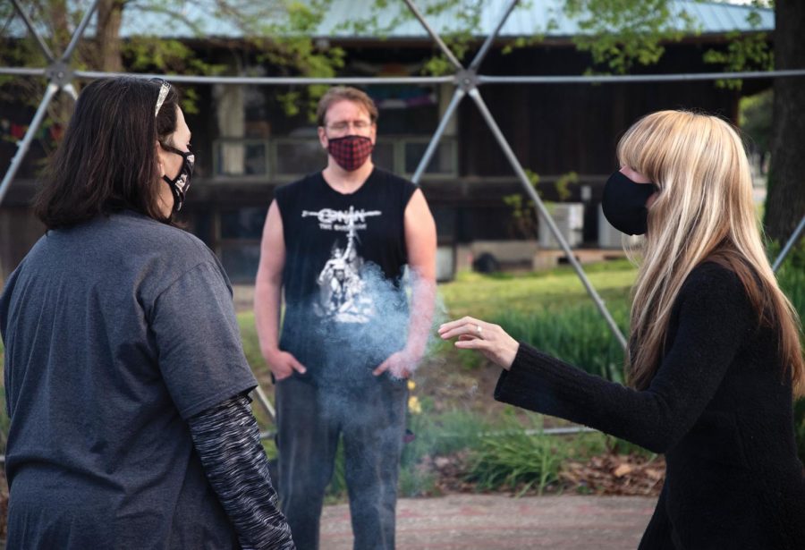 Tara Nelson, the leader of Southern Illinois Pagan Alliance (SIPA) performs smudging over SIPA member, Andy Darnelle, on Wednesday April 14, 2021, inside the Labyrinth near Gaia House Interfaith Center, in Carbondale Ill. “We couldn’t do any events after the pandemic hit and its been a year. We are looking forward to doing some rituals following the COVID guidelines,” Nelson said.