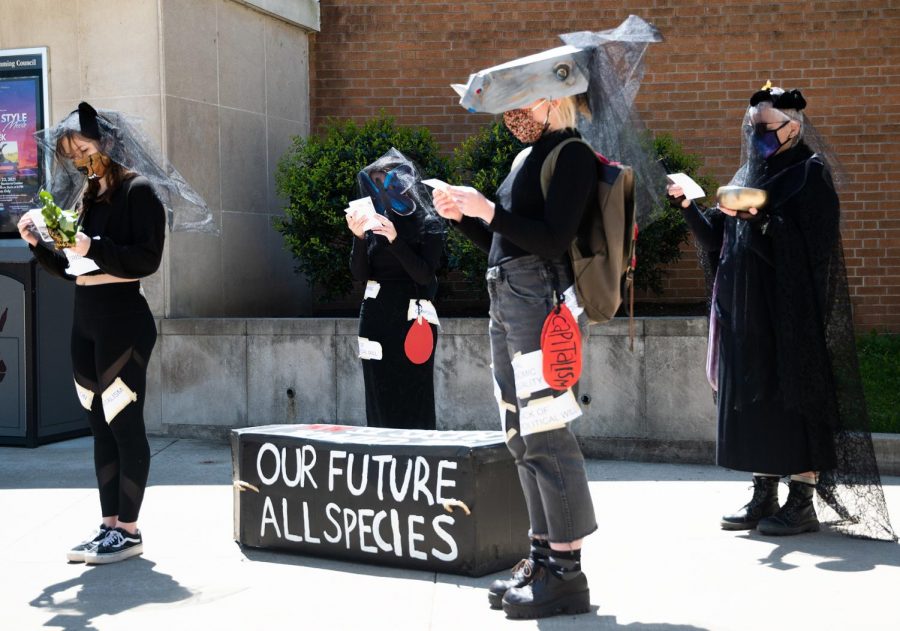 Students in SIUs Art and Activism class read messages about the extinction of animals due to climate change during the funeral casket procession in honor of countless species of animals that have gone extinct on Thursday, April 22, 2021 at the Communications Building in Carbondale, Ill. 