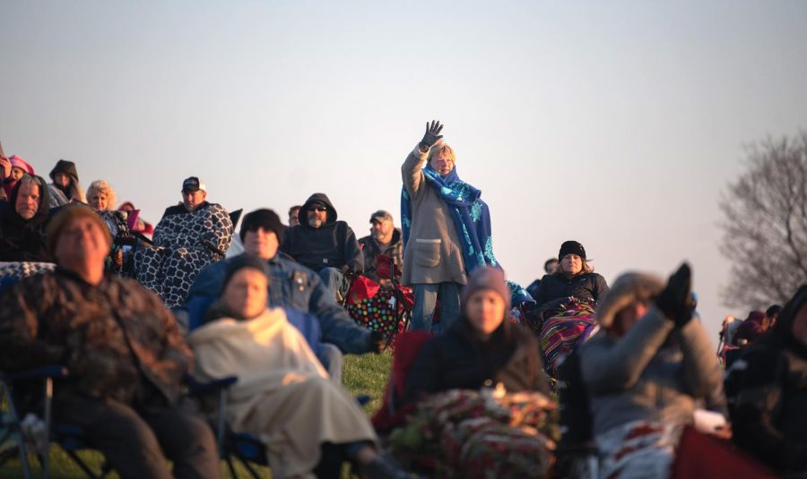 A woman stands during the worship at the Easter Sunrise Service at Bald Knob Cross on Sunday, April 4, 2021 in Alto Pass, Ill.