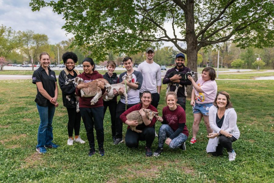 Some of the Daily Egyptian staff pose with the goats during goat yoga on April 17, 2021 in Carbondale, Ill.