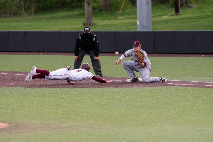 Outfielder Tristen Peters (6) slides back to first and makes it safe in the first inning during the game against Bellmore on April 10, 2021 at Itchy Jones Stadium in Carbondale, Ill.