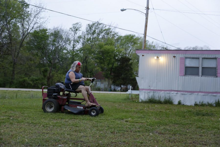 Susan Stone mows the lawn on her property, Lenzburg, Ill., Tuesday, April 27, 2021.