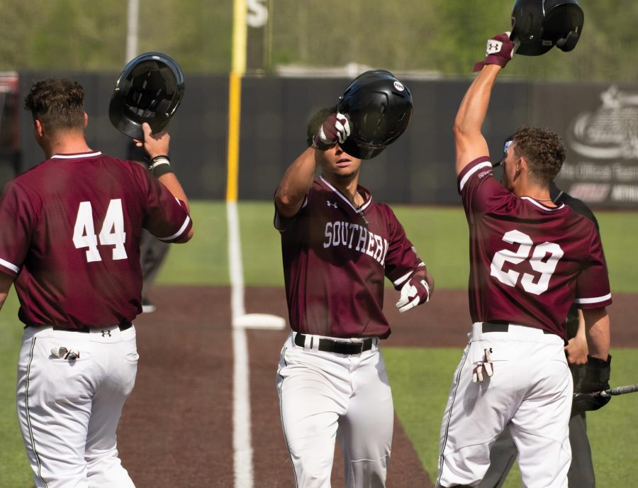 Philip Archer (44), Evan Martin (2) and Cody Cleveland (29) celebrate as they collect three homeruns in a game against Missouri State University on Saturday, May 1, 2021, at Itchy Jones Stadium in Carbondale Ill. The game took a U-turn in the sixth inning when 4-1 down saluki climbed two steps ahead of MSU making score of 4-6. 