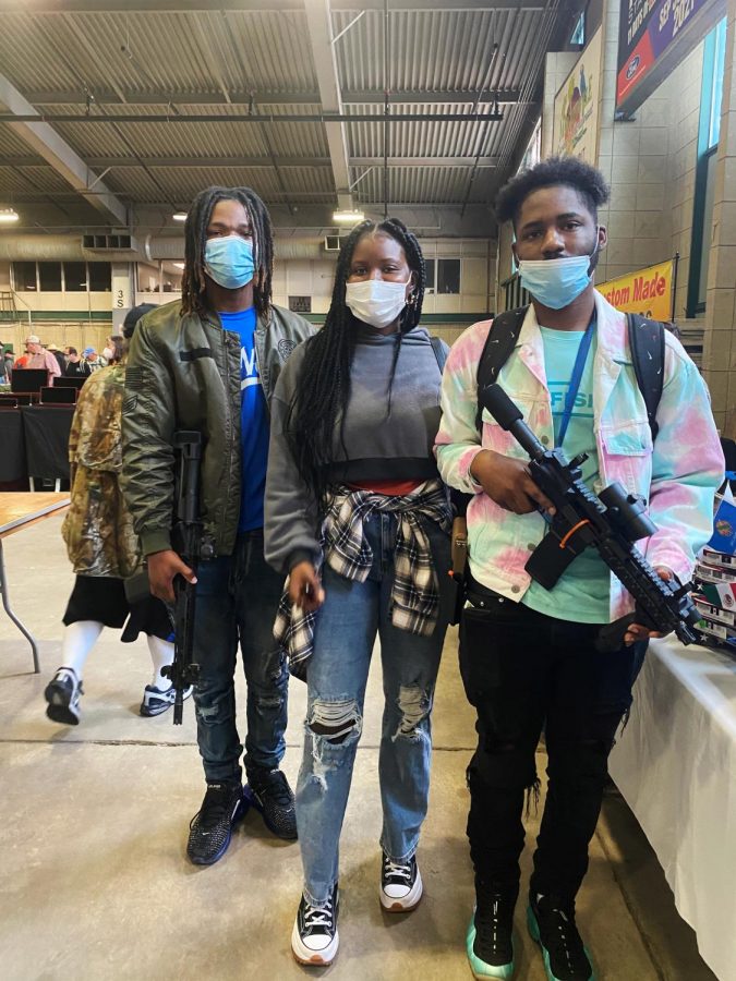 Jamarian Thomas (right) poses for a portrait with his friends at the Wanenmacher’s Tulsa Arms Show on April 10 and 11, 2021, in Tulsa, Okla. “I think the biggest misconception is that guns kill people but people kill people,” Thomas said.
