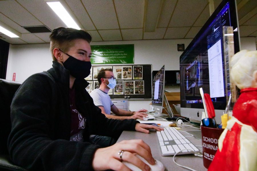 (Pictured from left to right) Chloe Schobert the Design Chief, and Dustin Clark a Designer working in the Daily Egyptian Newsroom Aug. 16, 2021 at Southern Illinois University Carbondale. The newsroom is located within the Communications building on the SIU campus. 