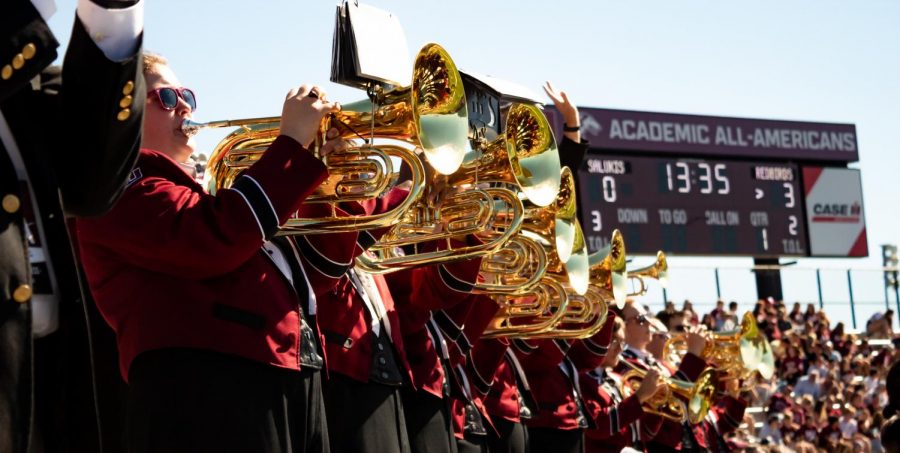 Marching Salukis’ brass section plays at the Football game Sept. 25, 2021 during Family Weekend at the SIU Saluki Stadium in Carbondale, Ill. 