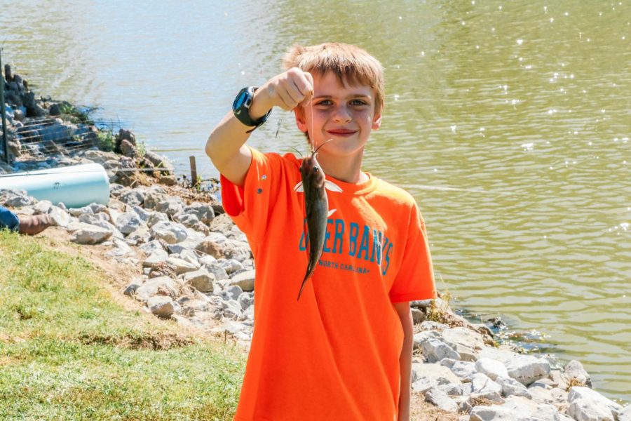 Gavin Gants poses for the camera after catching his first fish of the day Sept. 26, 2021 at Southern Illinois Hunting and Fishing Days in Carbondale, Ill. We all love to go out and fish and its great to be outside and see the animals, Crystal Grant, Gavins mother said.