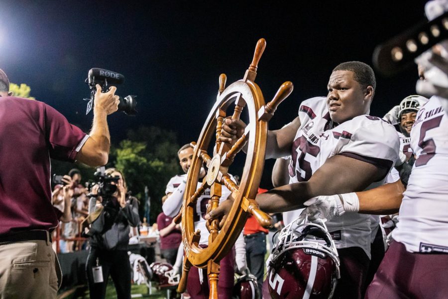 Calvin Francis Jr. (65) holds the wheel won by the Salukis after the War for the Wheel Sept. 2, 2021 at Houck Stadium in Cape Girardeau, Mo. The War for the Wheel game is held each year as the season opener of SIU against SEMO.