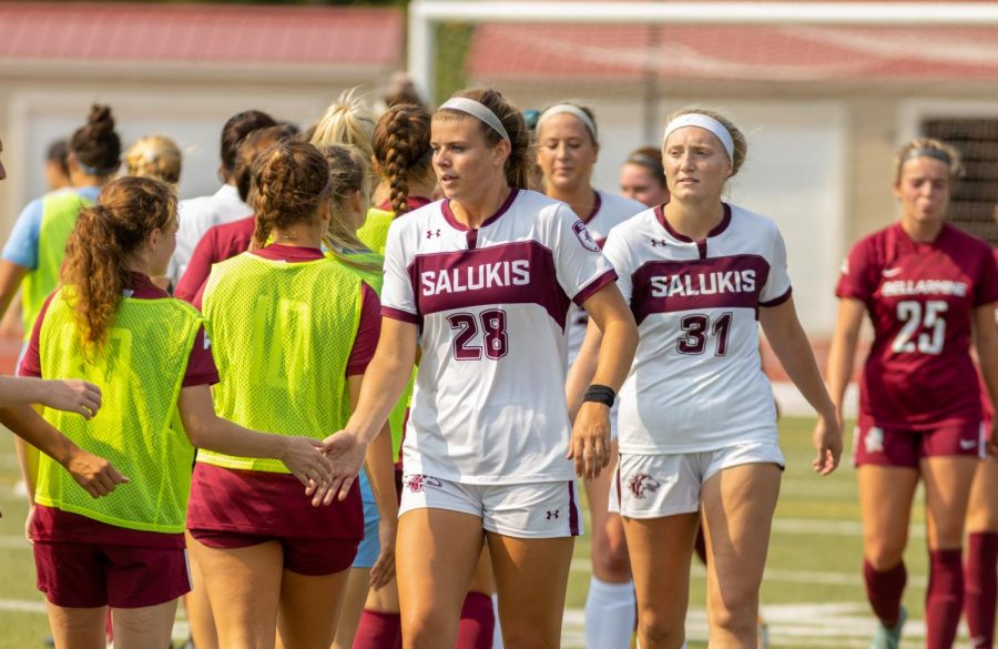 SIUs McKensey Bunch, left, and Paris Walsh, right, high five members of the Bellarmine soccer team after the Salukis game against Bellarmine University, where the Knights won 2-0 against the Salukis on Sunday, Sept. 12, 2021 at Lew Hartzog Track and Field Complex at SIU.  