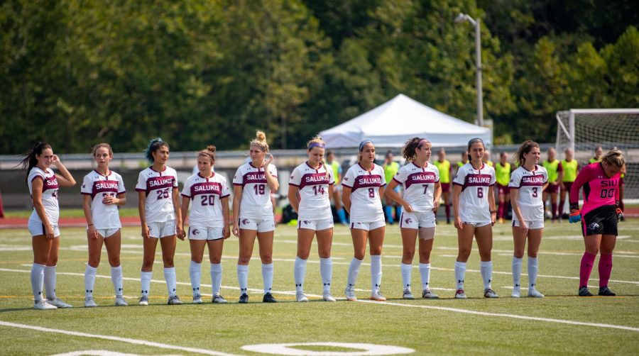 The SIUs womens soccer team stands at the beginning of the Salukis game against Bellarmine University, where the Knights won 2-0 against the Salukis on Sunday, Sept. 12, 2021 at Lew Hartzog Track and Field Complex at SIU.  