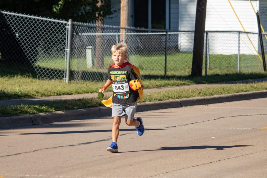A child runs across the finish line at the For Kids Sake Superhero 5K Sept. 25, 2021 in Carbondale, Ill. 