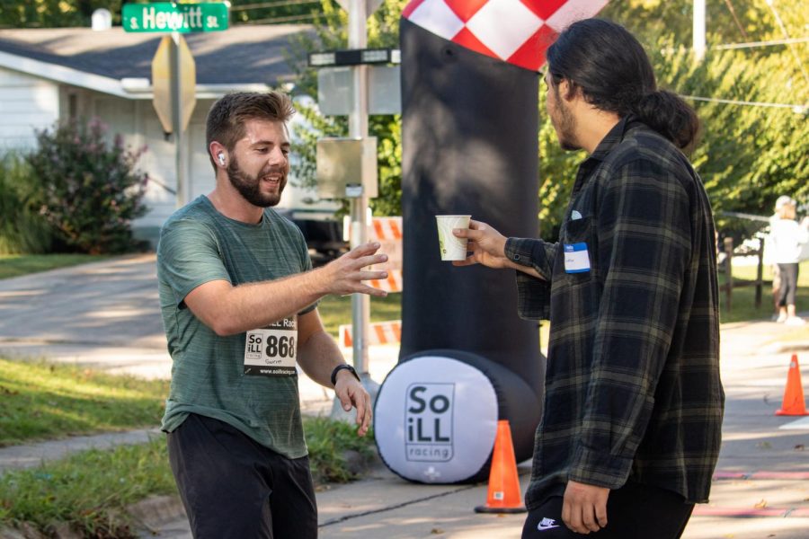 Garrett Stritzel, age 21, accepts water after finishing in fifth place at the Superhero 5K Sept. 25, 2021 in Carbondale, Ill. 