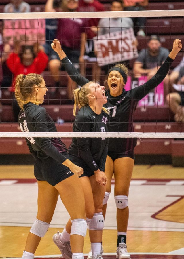 Tatum Tornatta, left, reacts with her teammates Anna Jaworski, middle, and Nataly Garcia, right, after a scoring play during the Salukis a 3-0 match win over the University of South Carolina - Upstate on Friday, Sept. 10, 2021 during the Saluki Invitational at the Banterra Center at SIU. 