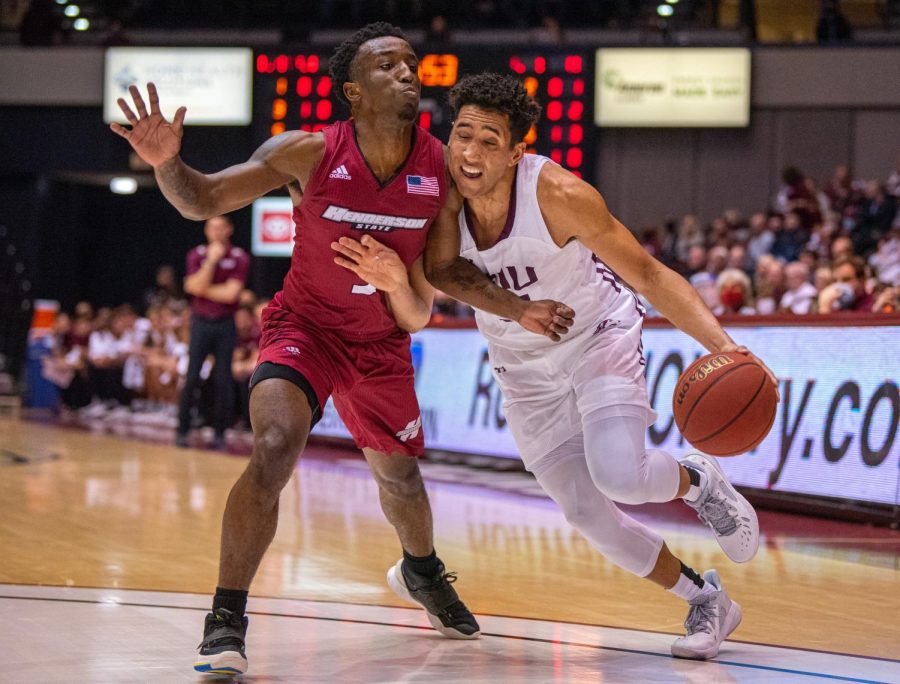 SIU guard, Dalton Banks, drives into a Reddies defender during the Salukis' 66-52 win during an exhibition game against Henderson State on Tuesday, Oct. 26, 2021 at the Banterra Center at SIU. 