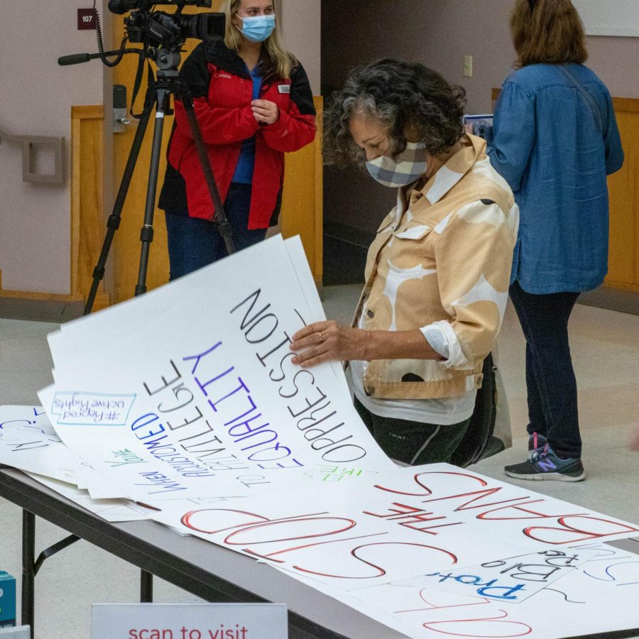 Activist looks at posters that people have made at the March for Reproductive Rights Oct. 2, 2021 in Carbondale, Ill. 