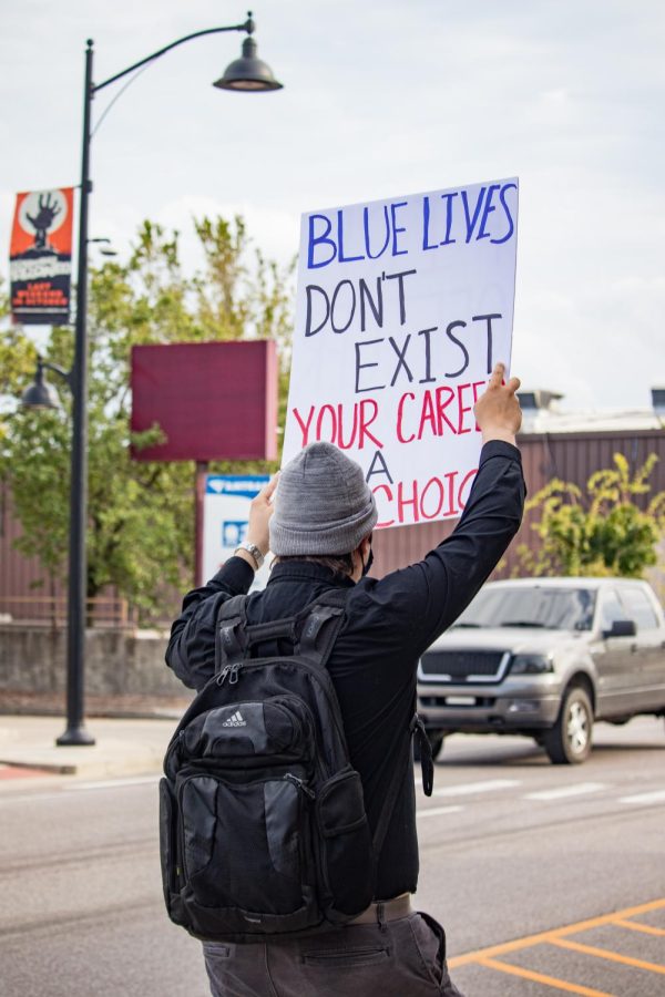Victor Ludwig holds a sign that reads Blue Lives Dont Exist Your Carer Is A Choice during the March for Mattie protest Oct. 13, 2021 in Carbondale, Ill. 