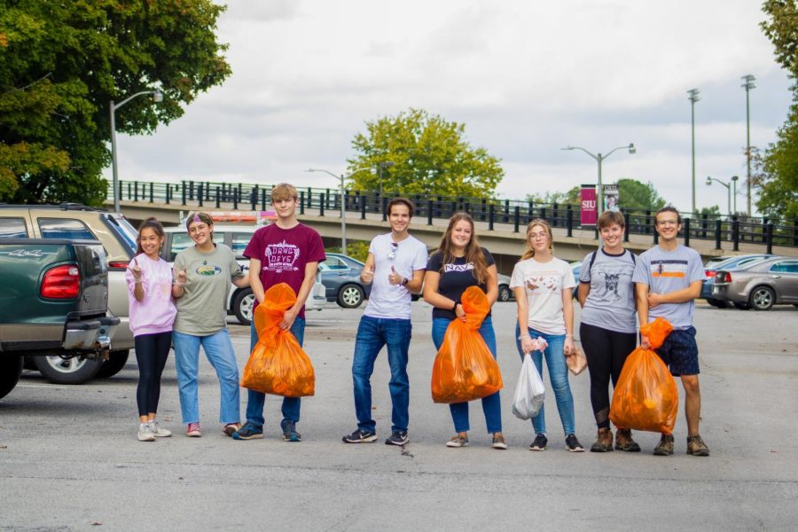 (Pictured from left to right) Madison Piazza, Kiva Schobernd, Elijah Bush, Matthew Kovich, Sarah O’Connor, Alex Barnes, Leah Kleiman, and Caleb Hoffman help pick up trash near SIU with the Gaia House Interfaith Center for service hours Oct. 3, 2021 in Carbondale Ill. 