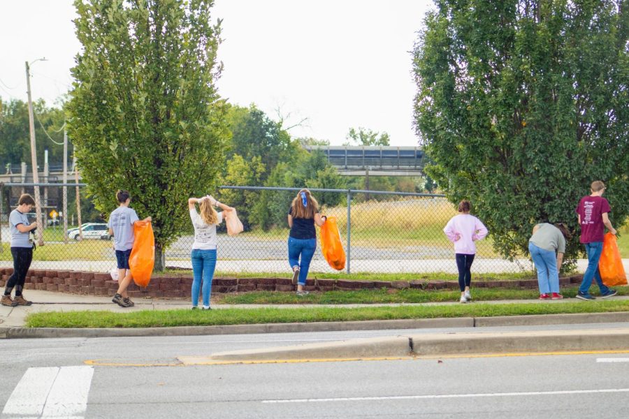 (Pictured from left to right) Leah Kleiman, Caleb Hoffman, Alex Barnes, Sarah O’Connor, Madison Piazza, Kiva Schobernd and Elijah Bush pick up trash they find on the side of the street Oct. 3, 2021 on E Grand Avenue in Carbondale Ill. 