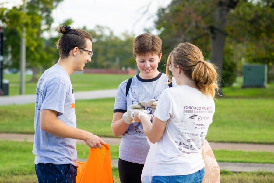 (Pictured left to right) Caleb Hoffman, Leah Kleiman, and Alex Barnes look at broken tiles they found while they pick up trash in the surrounding area Oct. 3, 2021 in Carbondale Ill. 