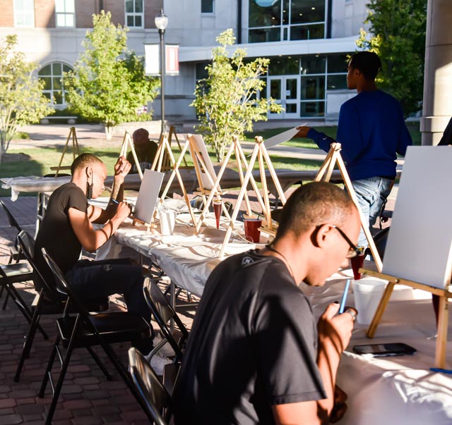 Students decide what they want to paint at the Paint & Sip hosted by the Black Affairs Council in the Student Services Building Pavilion at SIU Oct. 20, 2021 in Carbondale, Ill.
