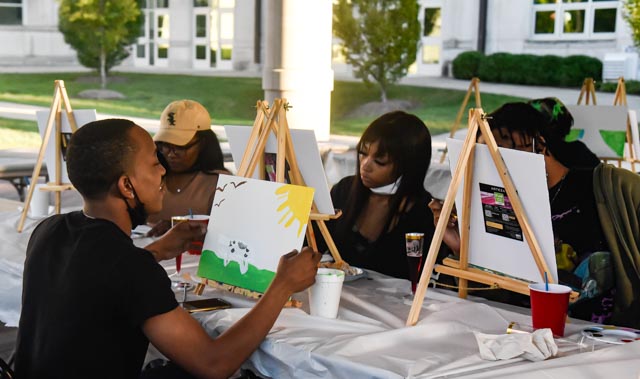 Students look at their paintings at the Paint & Sip hosted by the Black Affairs Council in the Student Services Building Pavilion at SIU Oct. 20, 2021 in Carbondale, Ill.