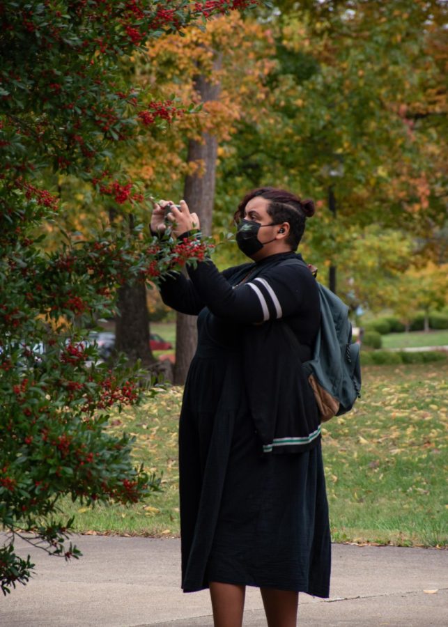Madison Peterson takes a photo of the landscaping on campus between her classes Nov. 1, 2021 at SIU in Carbondale, Illinois. Peterson is 