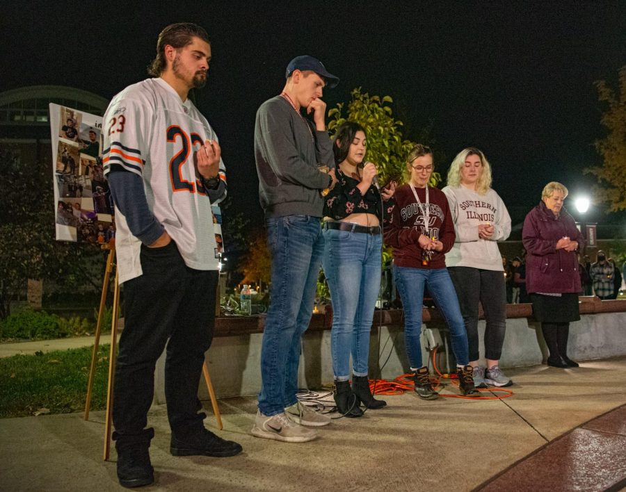 A group of friends close to Jacob Jurinek stand by  Emma Braning, Jurineks girlfriend, as she addresses the crowd of attendees during the vigil for Jurinek. Jurinek, a SIU student, who was among the victims of the Astroworld festival tragedy on Nov. 5 in Houston on Monday, Nov. 8, 2021 at Faner Plaza at SIU in Carbondale, Illinois.